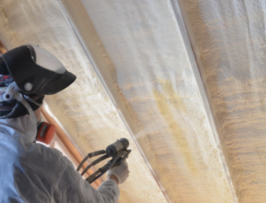 spray foam contractor spraying roof insulation